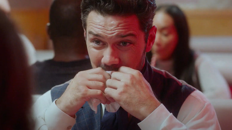 Ryan Paevey holding napkin to face