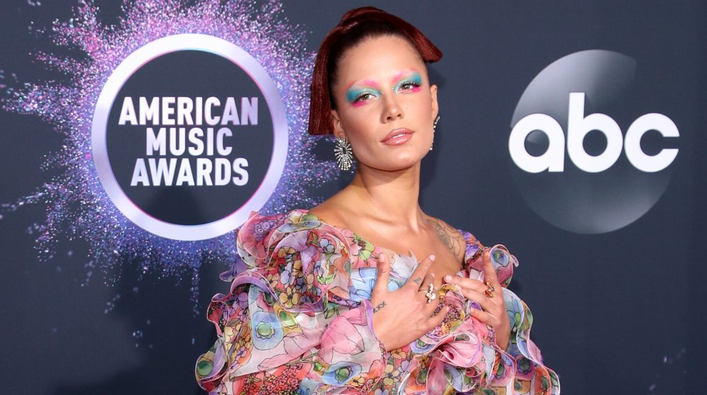 Halsey with rainbow-colored makeup in a floral dress