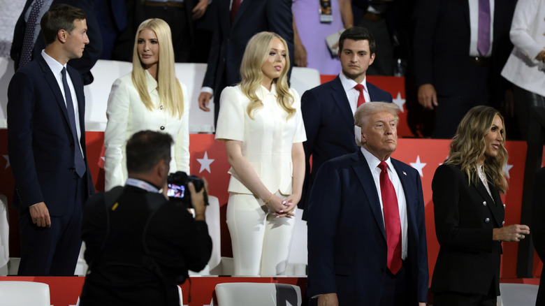 The Trumps standing up in stands