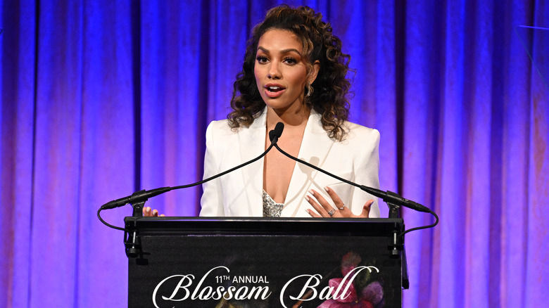 Corinne Foxx speaking at podium