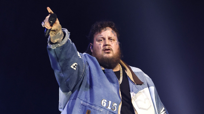 Jelly Roll on stage pointing at crowd