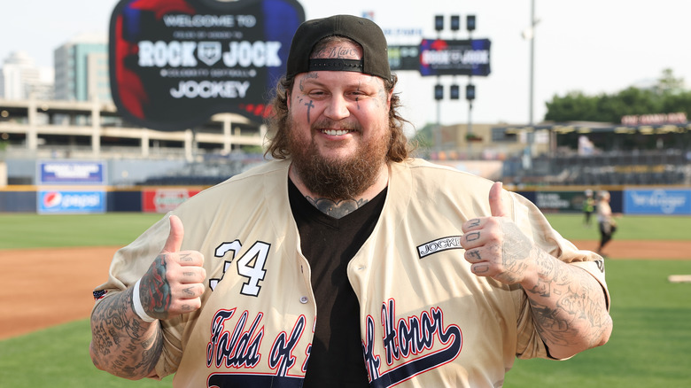 Jelly Roll giving thumbs up on a baseball field