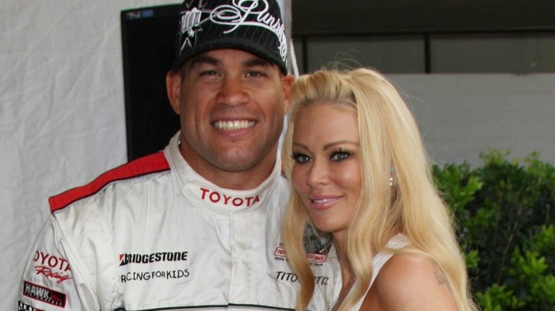 Jenna Jameson and Tito Ortiz smiling at a car racing event