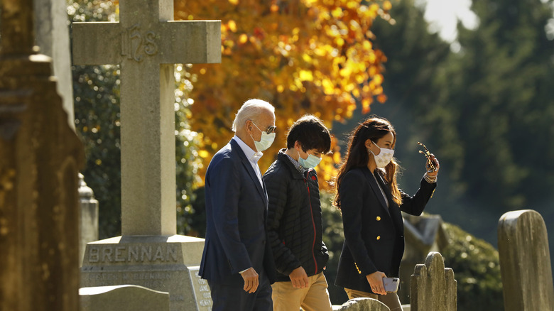 Joe Biden walks with grandson and Ashley through cemetary