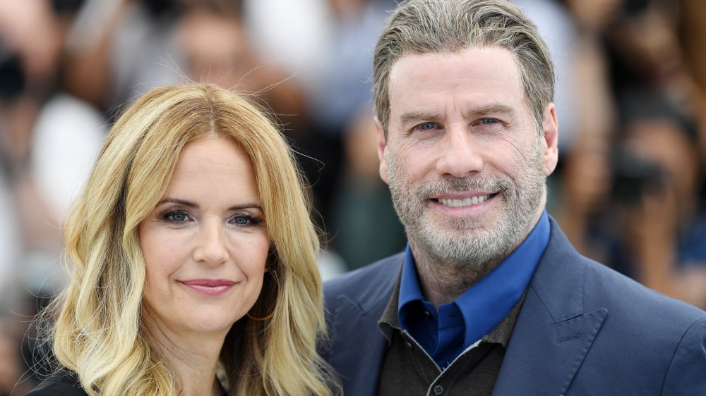 Kelly Preston and John Travolta smiling on red carpet