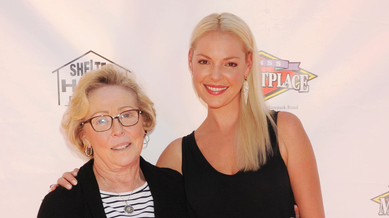 Nancy Heigl wearing a black sweater and black and white striped shirt with Katherine Heigl wearing a black tank top