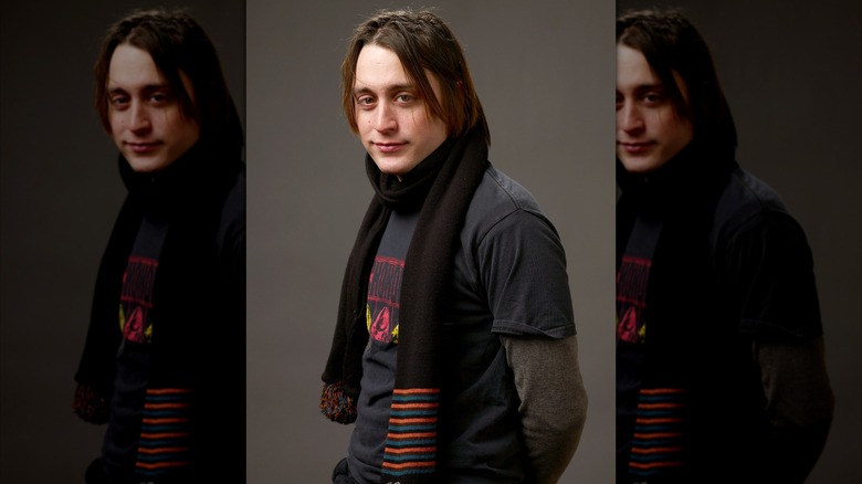 Kieran Culkin posing in scarf