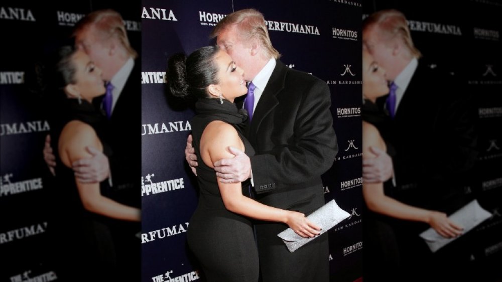 Kim Kardashian being kissed by Donald Trump