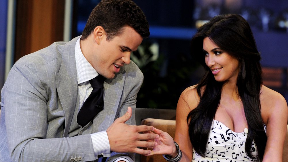 Kris Humphries and Kim Kardashian touching hands on The Tonight Show