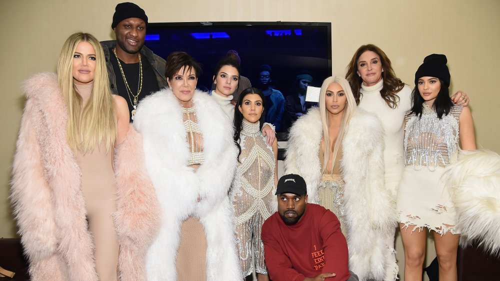 Lamar Odom, Kanye West and the Kardashian-Jenner family posing in fur coats for a group photo