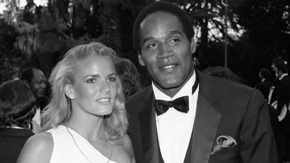 Nicole Brown Simpson and O.J. Simpson smiling at a formal event 