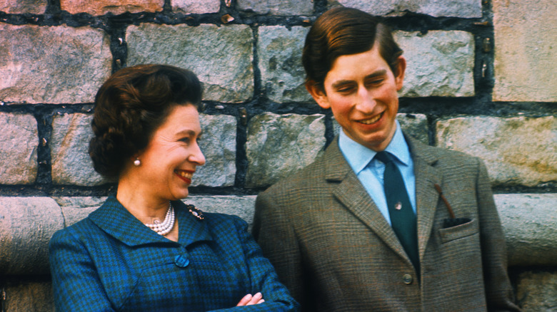 Queen Elizabeth II smiling with young Prince Charles