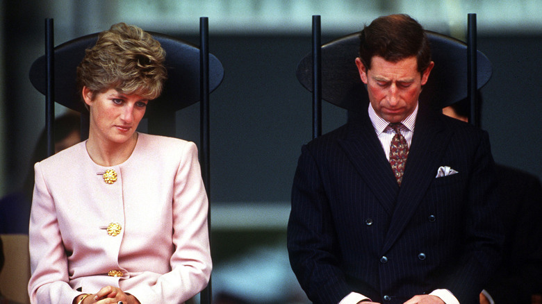 Princess Diana with Prince Charles head bowed