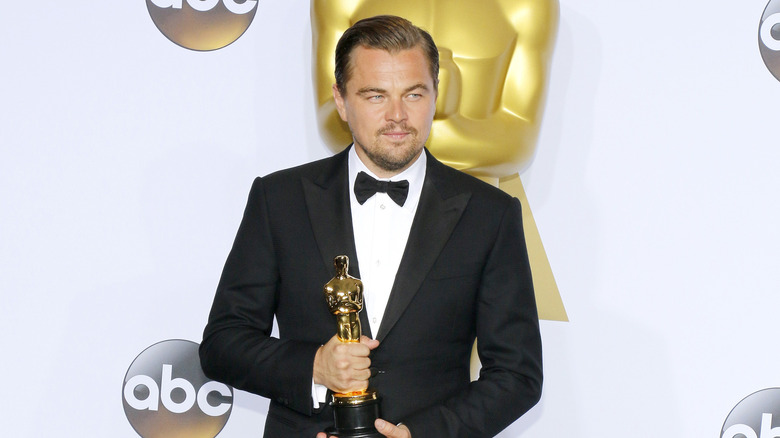 Leonardo DiCaprio posing with his Oscar award