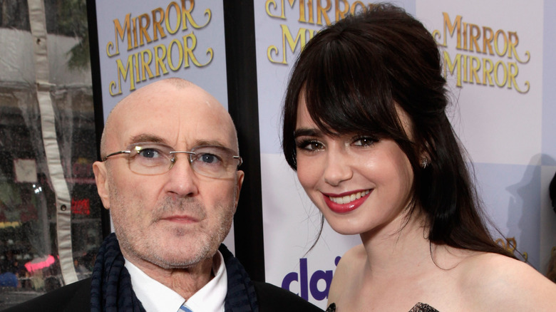 Lily poses with Phil Collins