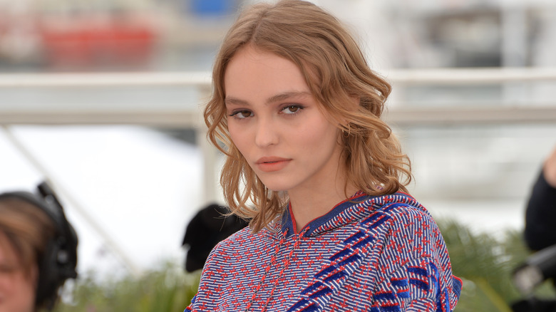 Lily-Rose Depp looks on