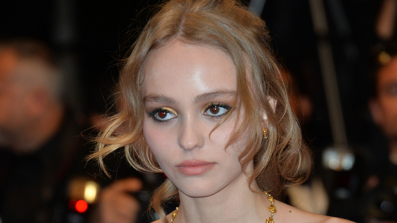 Lily-Rose Depp looks on