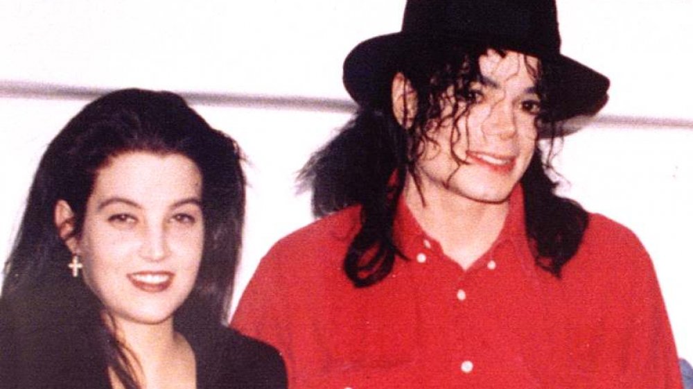 Lisa Marie Presley and Michael Jackson arm in arm