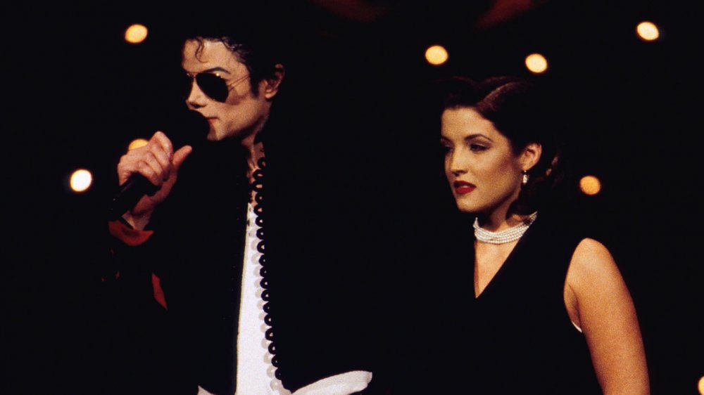 Michael Jackson performing and Lisa Marie Presley next to him 