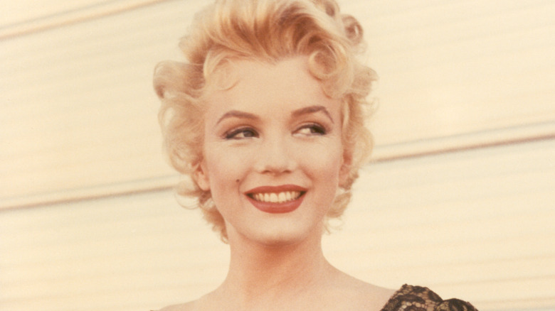 Marilyn Monroe smiling while looking off to the side