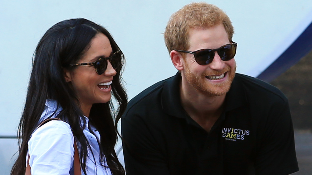 Meghan Markle and Prince Harry, both in sunglasses