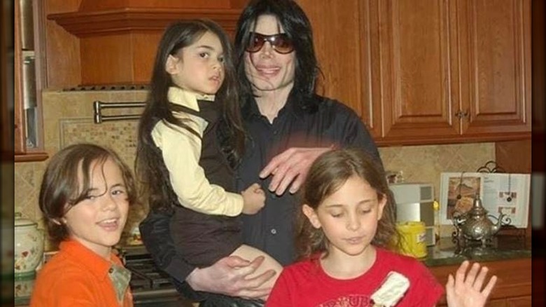 Prince Jackson smiling with Michael, Bigi, and Paris Jackson