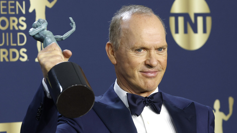 Michael Keaton holds award