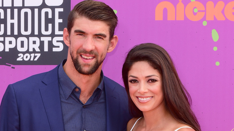 Michael Phelps and Nicole Johnson Phelps smiling