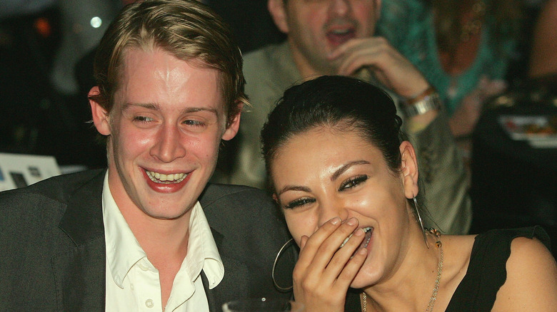 Macauley Culkin and Mila Kunis smiling