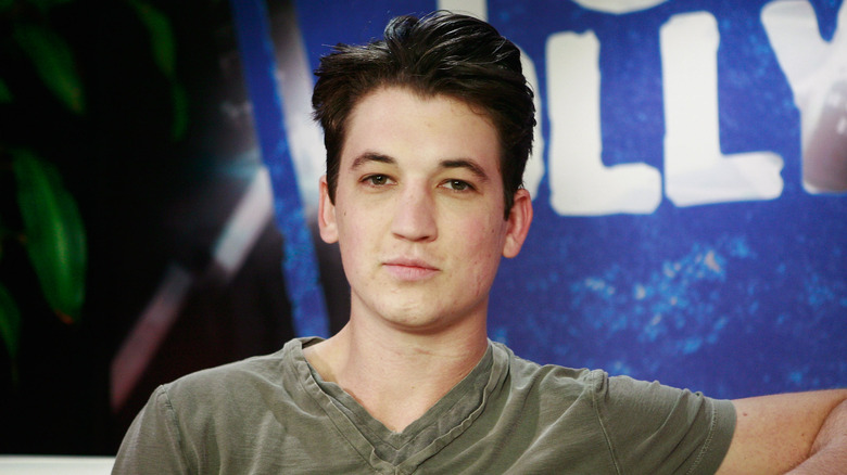 Young Miles Teller posing with faded scars