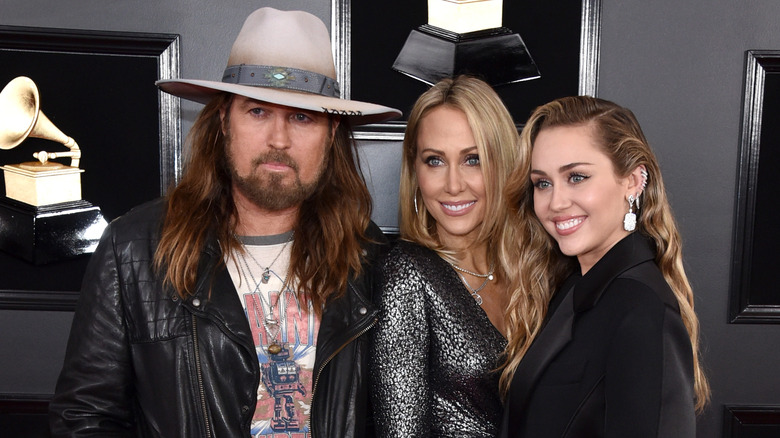 Miley poses with Billy Ray and Tish Cyrus