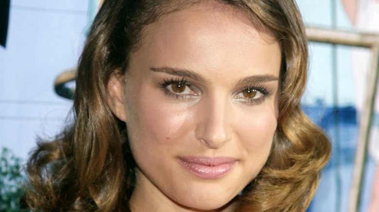 Natalie Portman with curly hair, smiling