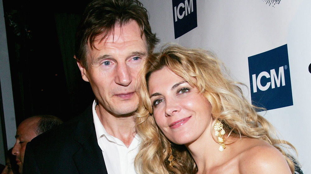 Natasha Richardson and Liam Neeson posing together at an event