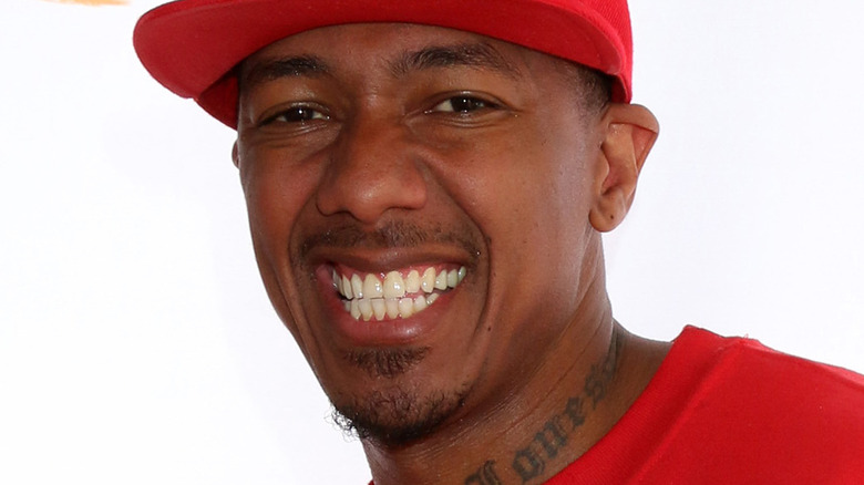 Nick Cannon wearing a red hat and red shirt 