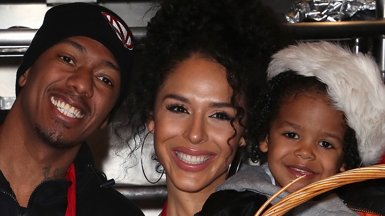 Nick Cannon posing with Brittany Bell and son Golden