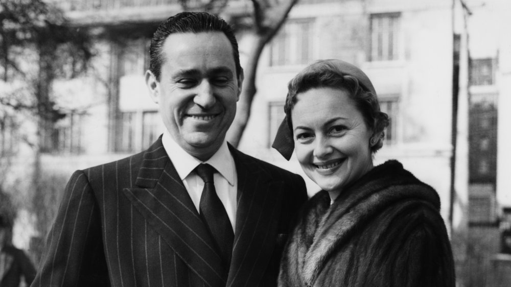 Pierre Galante and Olivia de Havilland smiling together ahead of their 1955 wedding