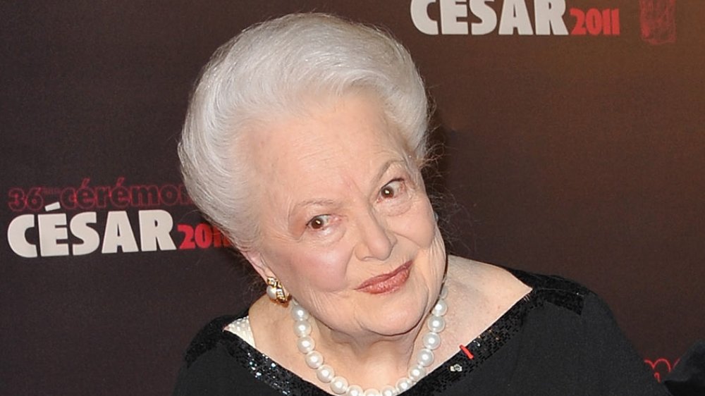 Olivia de Havilland smirking at the 2011 French Cesar Film Awards