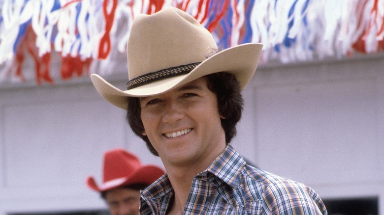 Young Patrick Duffy smiling in cowboy hat