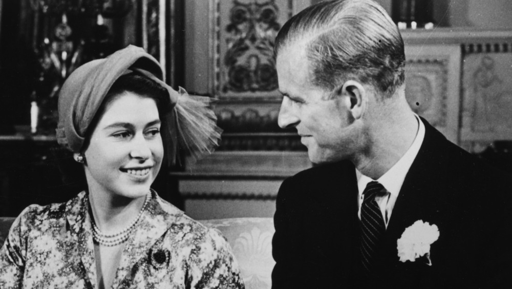 Prince Philip and Queen Elizabeth II smiling at each other