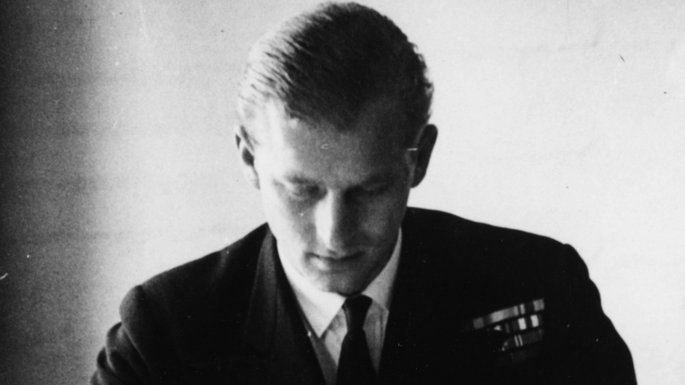 A young Prince Philip with his head down