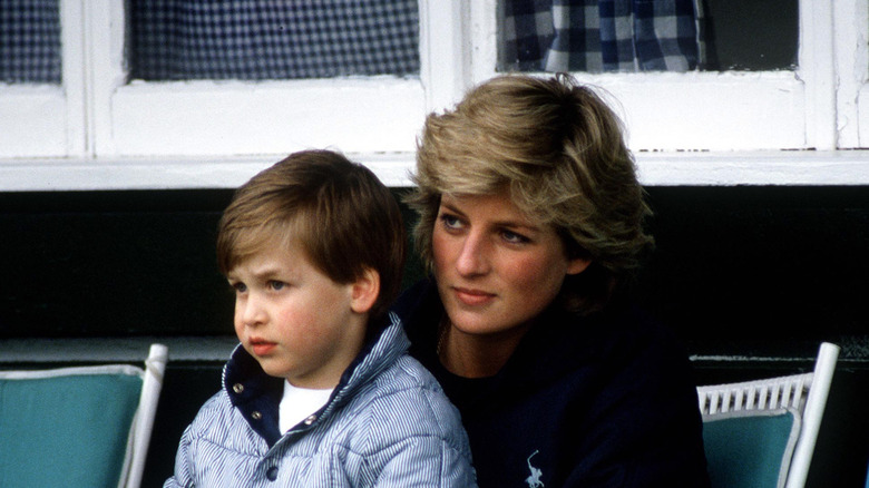 Young Prince William sitting on Princess Diana's lap