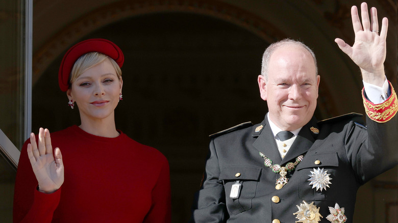 Princess Charlene red hat, Prince Albert waving