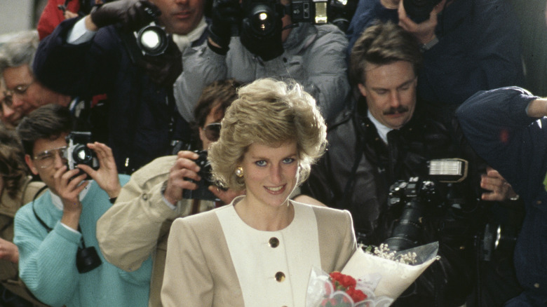 Princess Diana surrounded by paparazzi