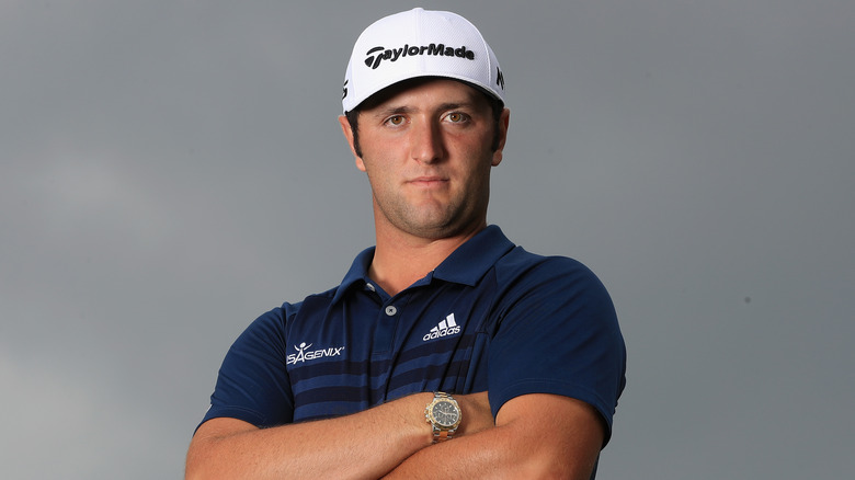 Jon Rahm posing on golf course