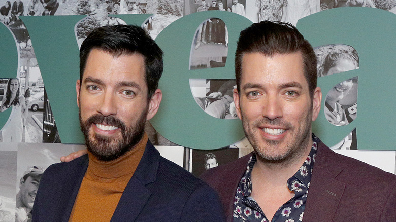 Drew and Jonathan Scott pose in suits