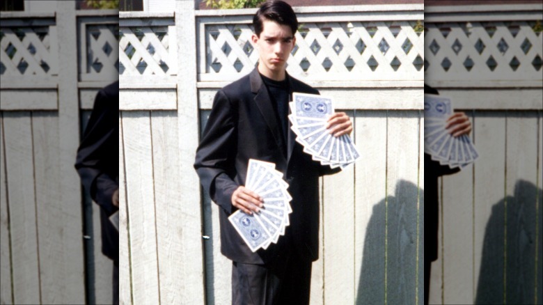 Young Jonathan Scott poses with cards