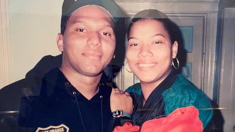 Queen Latifah and her brother smiling 