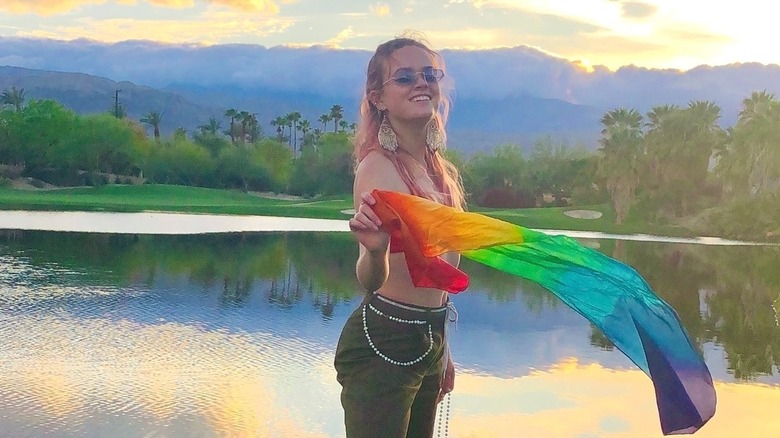 Ava Phillippe holds a rainbow flag