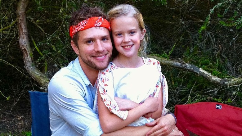 Young Ava sits in Ryan Phillippe's lap