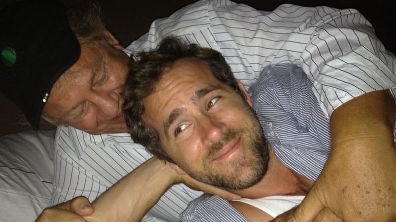 Ryan Reynolds lying with his father